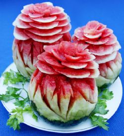 Water-melons are carved into flowers  and served as deserts at royal banquets.